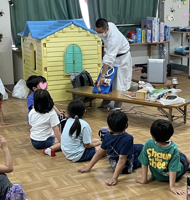 実験をする先生と、それを見る子供達